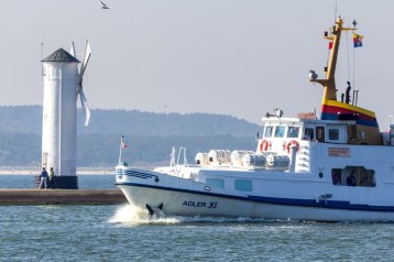 Sie sehen ein einfahrendes Seebäderschiff der Adler-Reederei vor der Mühlenbake in Swinemünde